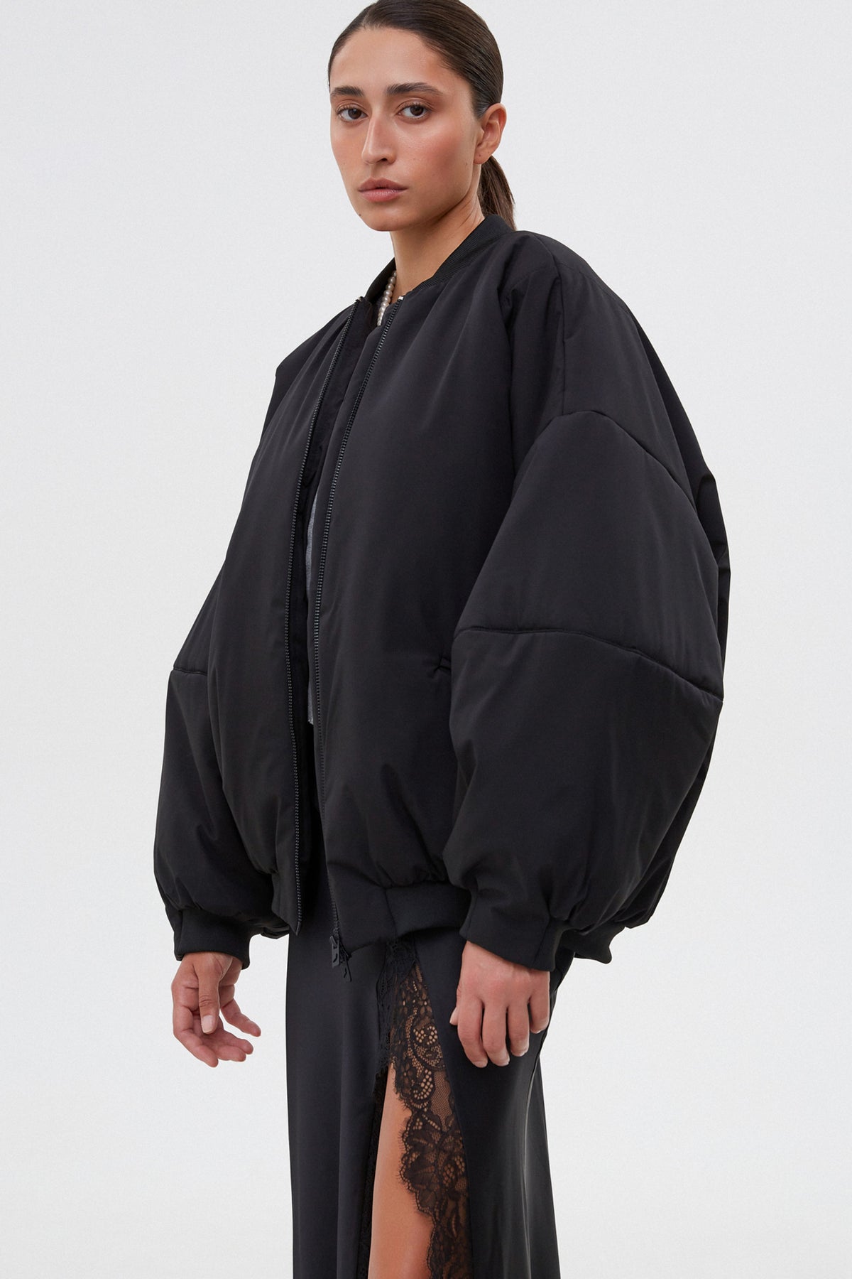 Women’s short black oversize bomber jacket with a stand collar.