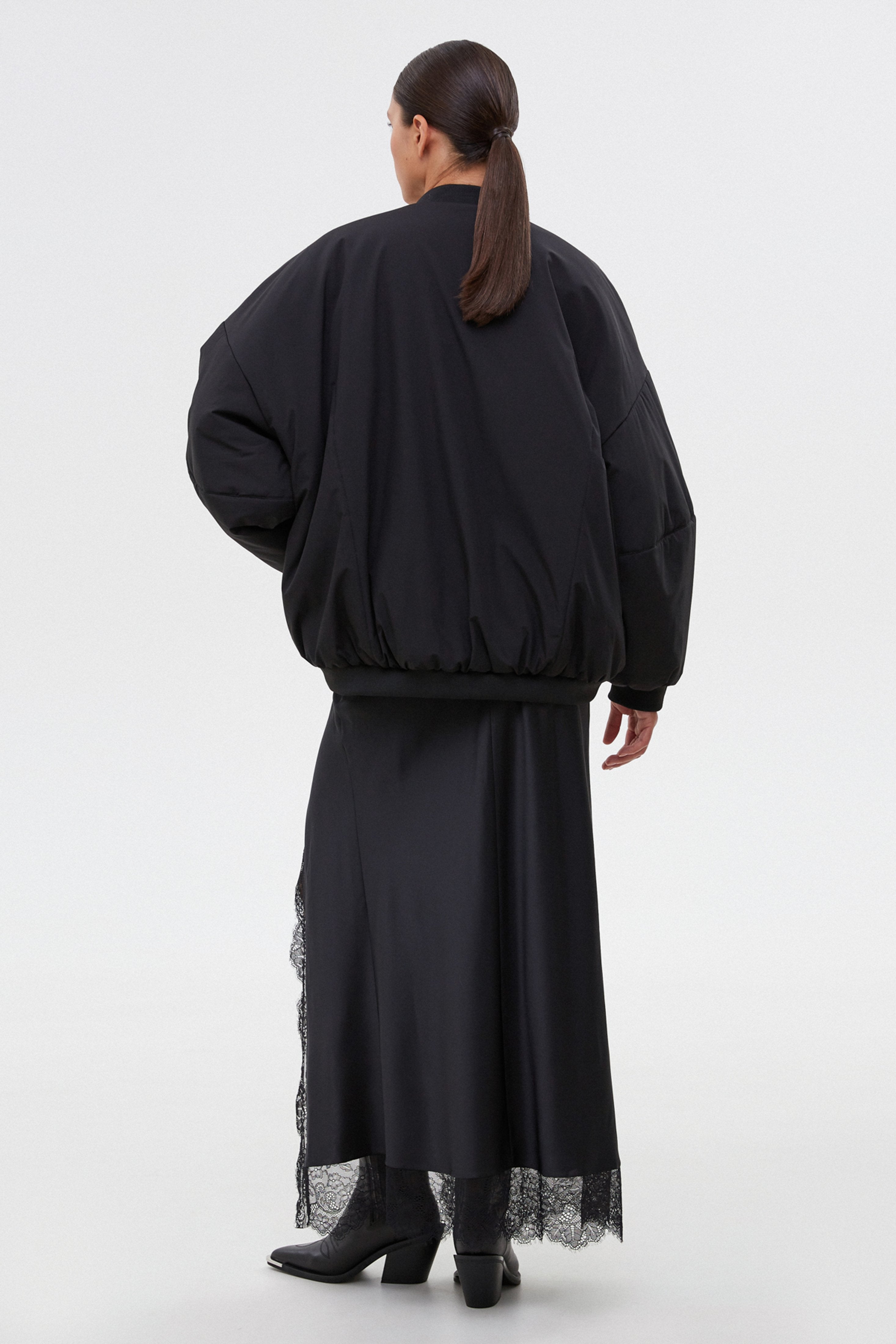 Women’s short black oversize bomber jacket with a stand collar by Estro.