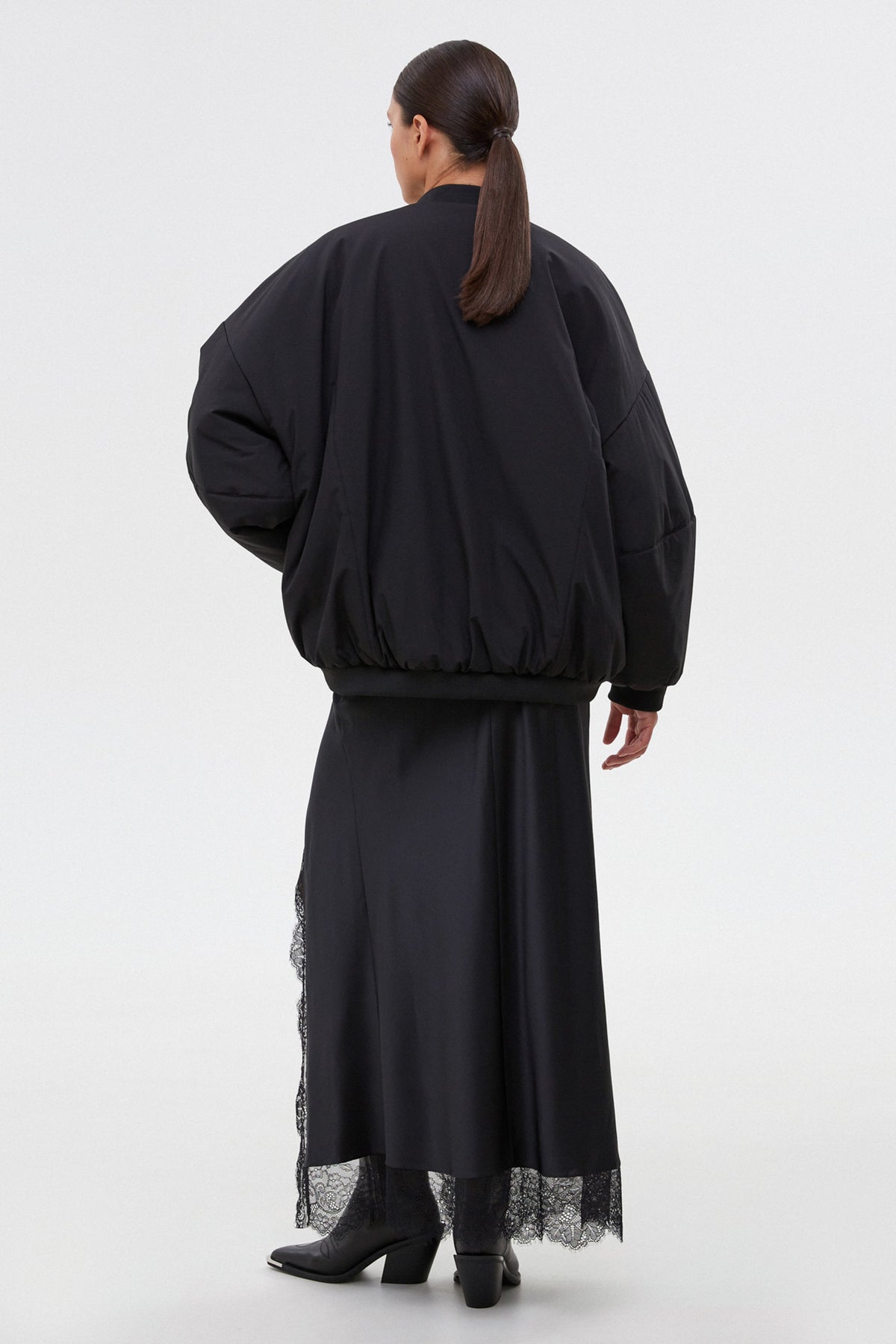 Women’s short black oversize bomber jacket with a stand collar by Estro.