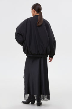 Women’s short black oversize bomber jacket with a stand collar by Estro.