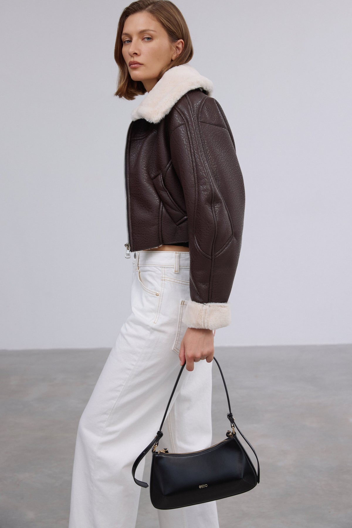 Women's short dark brown shearling jacket made of faux leather and fur by Estro.