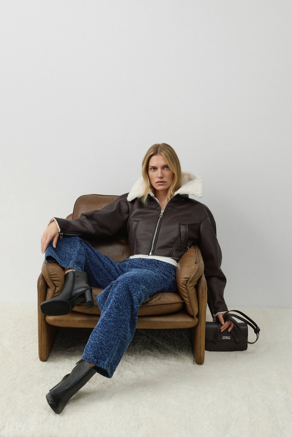 Women's short dark brown shearling jacket made of faux leather and fur by Estro.