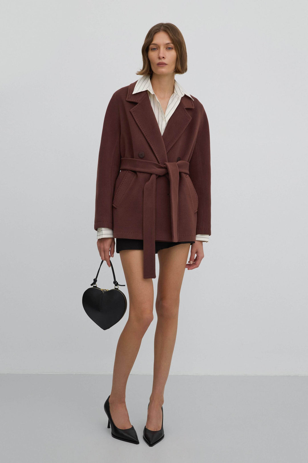 Stylish, short, double-breasted women's coat by Estro in a dark brown shade.