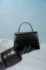 Small black women’s satchel handbag made of genuine leather.