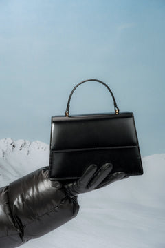 Small black women’s satchel handbag made of genuine leather.