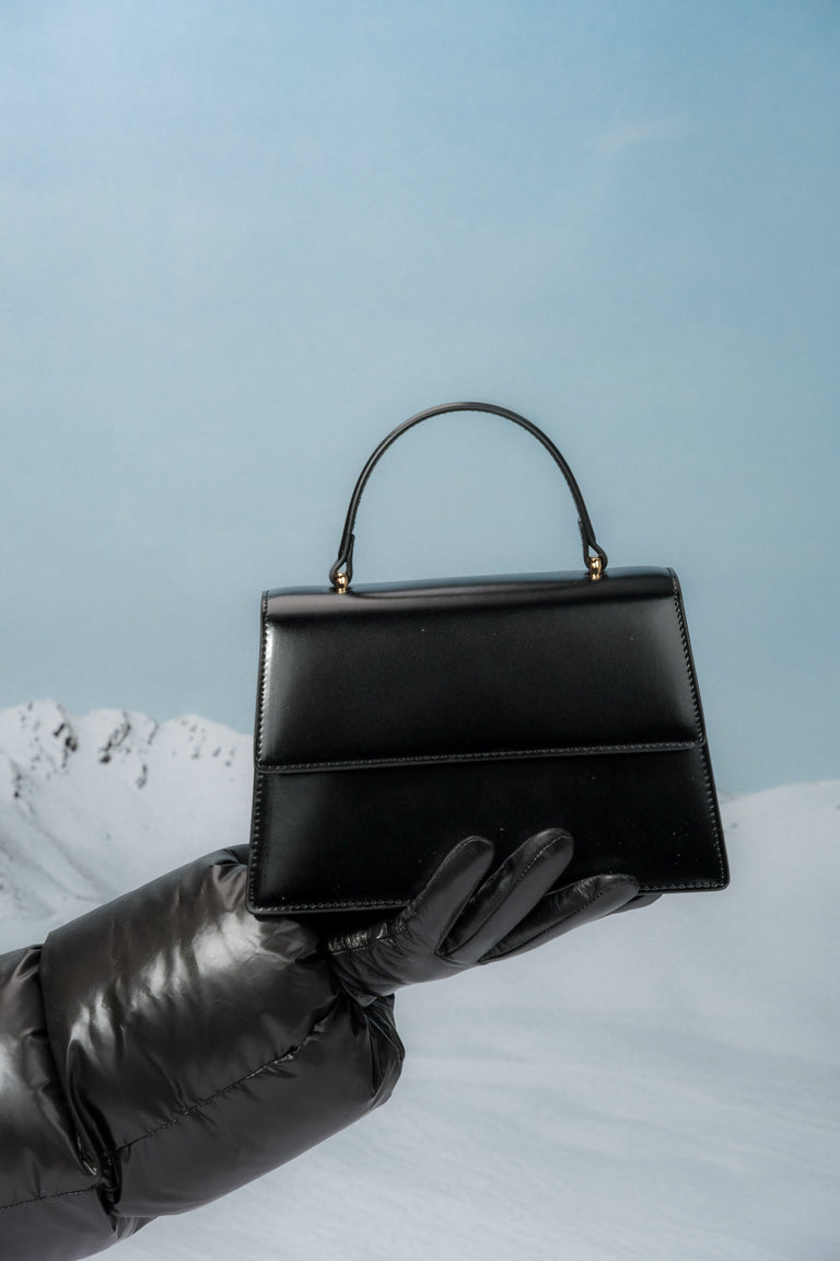 Small black women’s satchel handbag made of genuine leather.