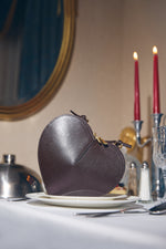 Women's small dark brown heart-shaped handbag made of genuine leather.