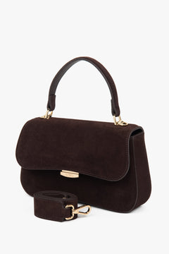 Small dark brown women’s satchel handbag made of genuine velour.