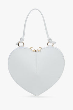 Heart-shaped white handbag with gold accents by Estro.
