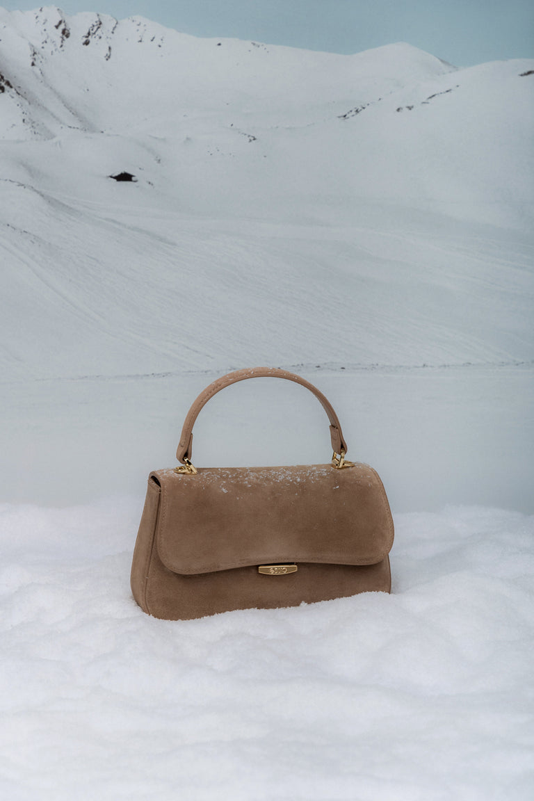 Small light brown women’s satchel handbag made of genuine velour.