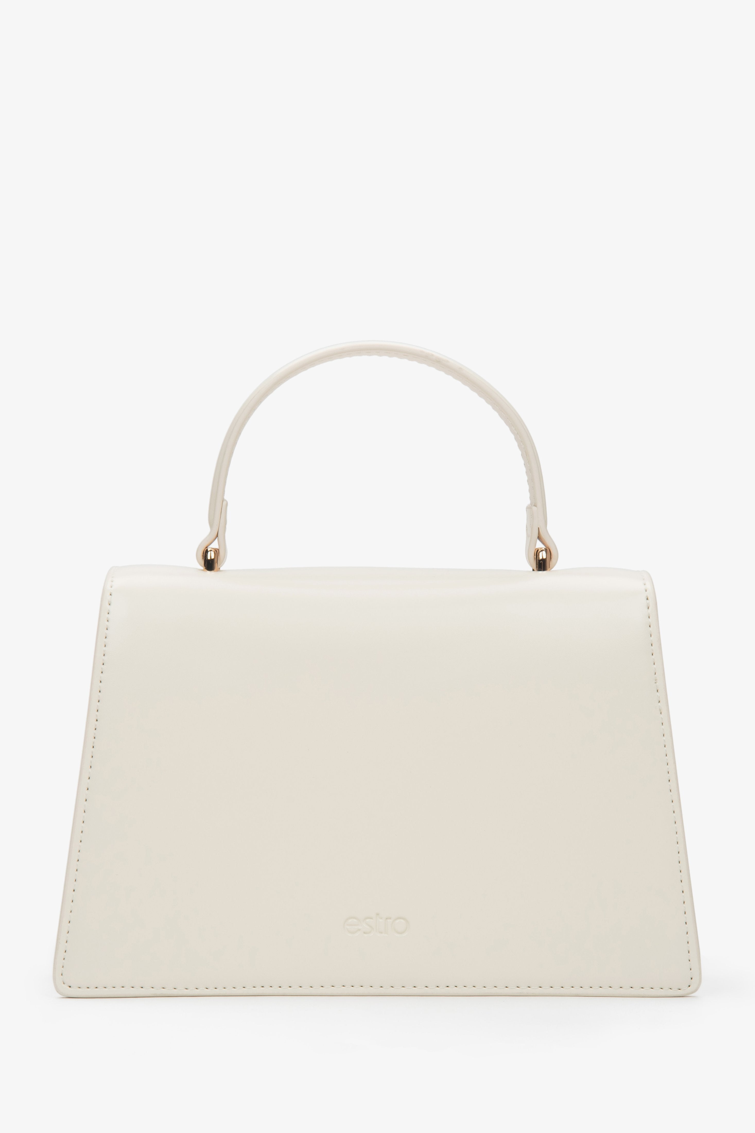 Small light beige leather handbag featuring a gold-tone snap closure and leather lining.