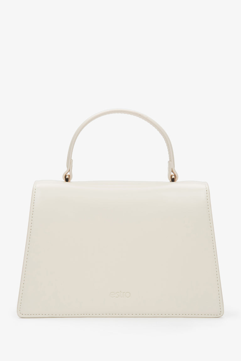 Small light beige leather handbag featuring a gold-tone snap closure and leather lining.