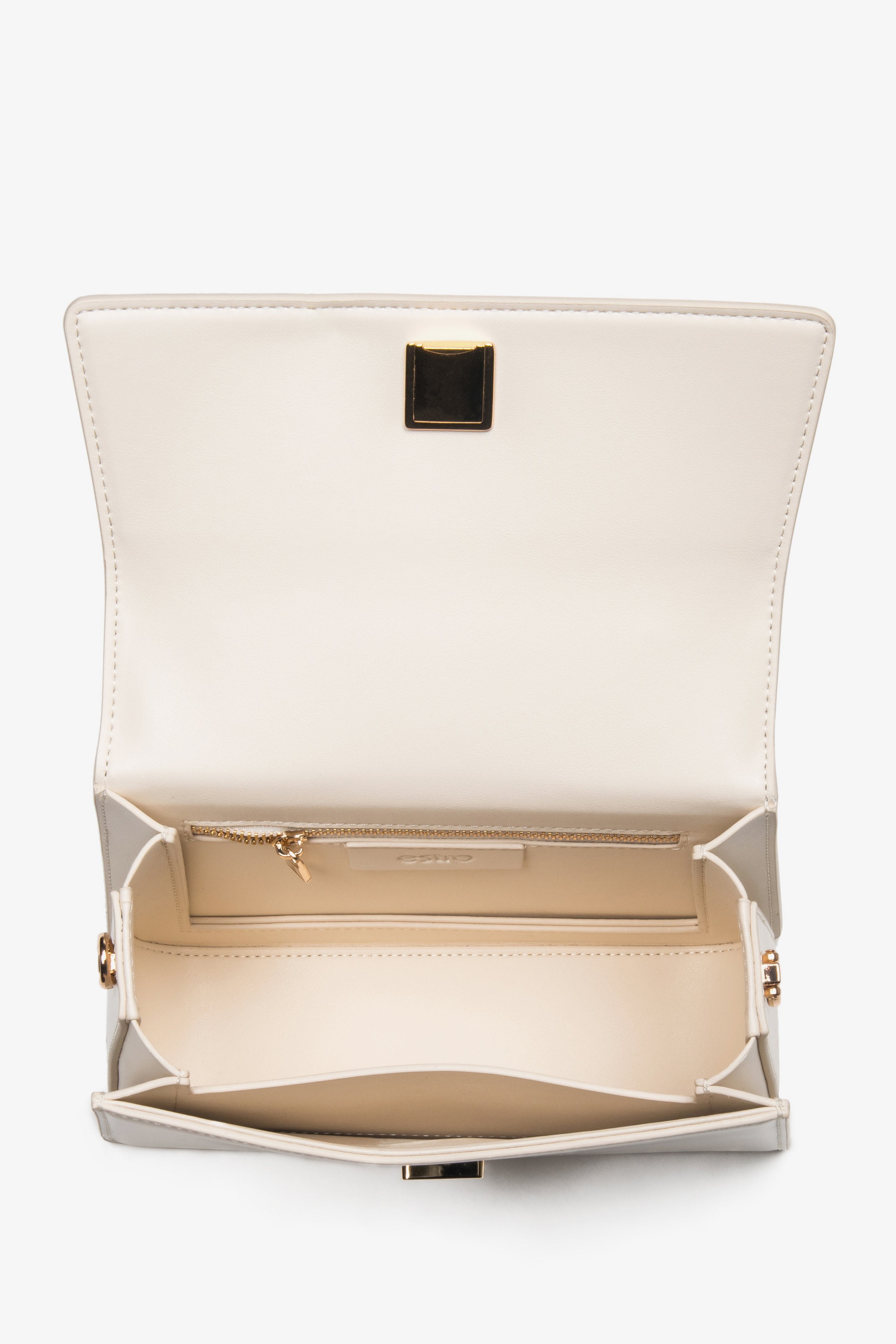 Close-up of the premium natural leather texture and gold-tone accents on a beige bag.