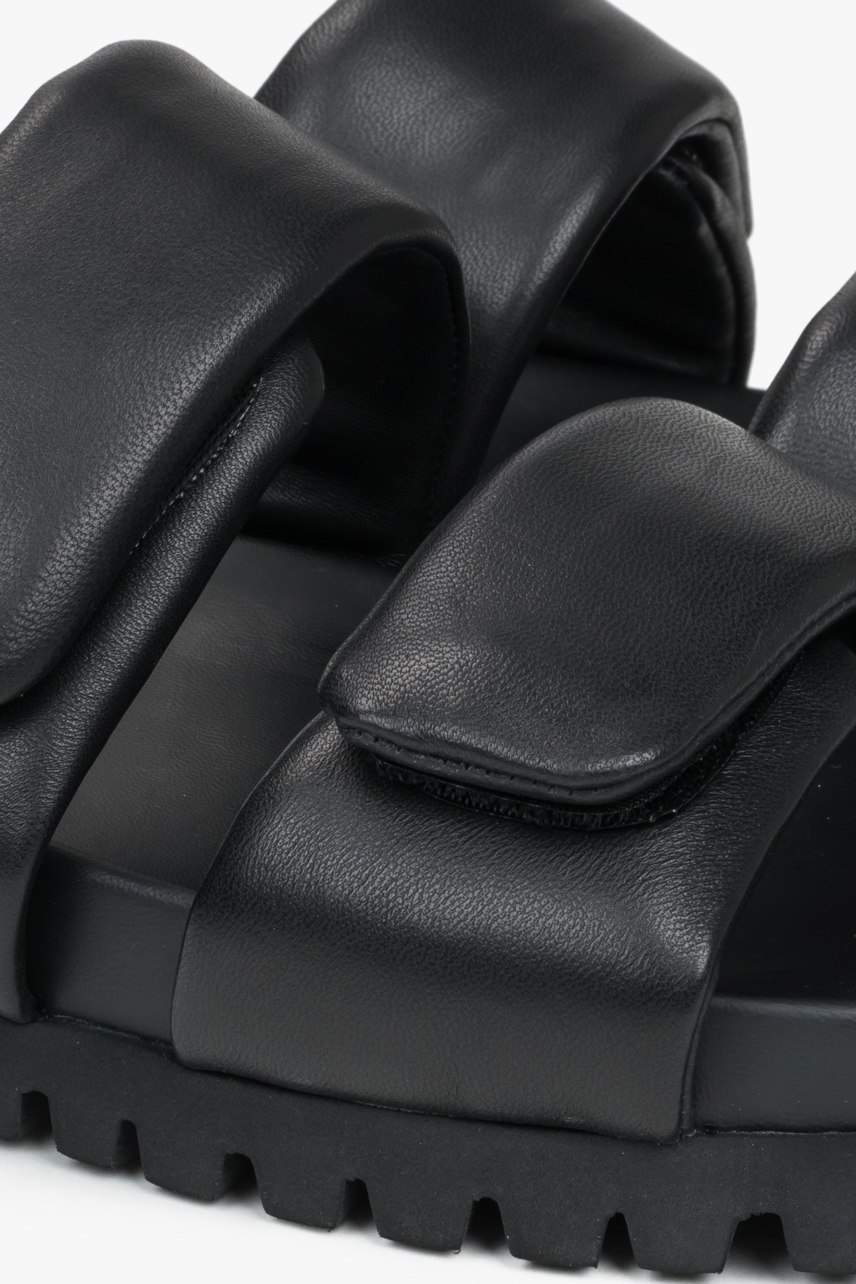 Black leather women's slides by Estro - a combination of genuine leather and soft straps - close-up of the details.