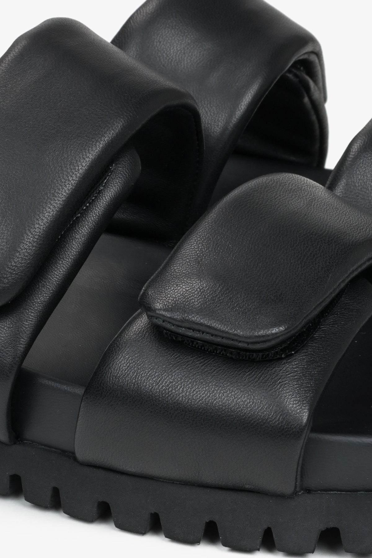 Black leather women's slides by Estro - a combination of genuine leather and soft straps - close-up of the details.