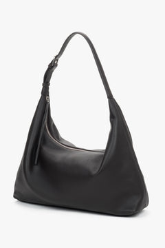 Elegant dark brown leather shopper featuring a secure zipper and adjustable strap.