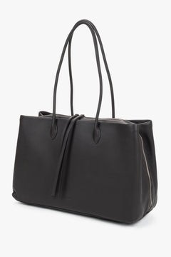 Spacious shoulder bag made of natural leather. The dark brown shade serves as an elegant alternative to classic black.