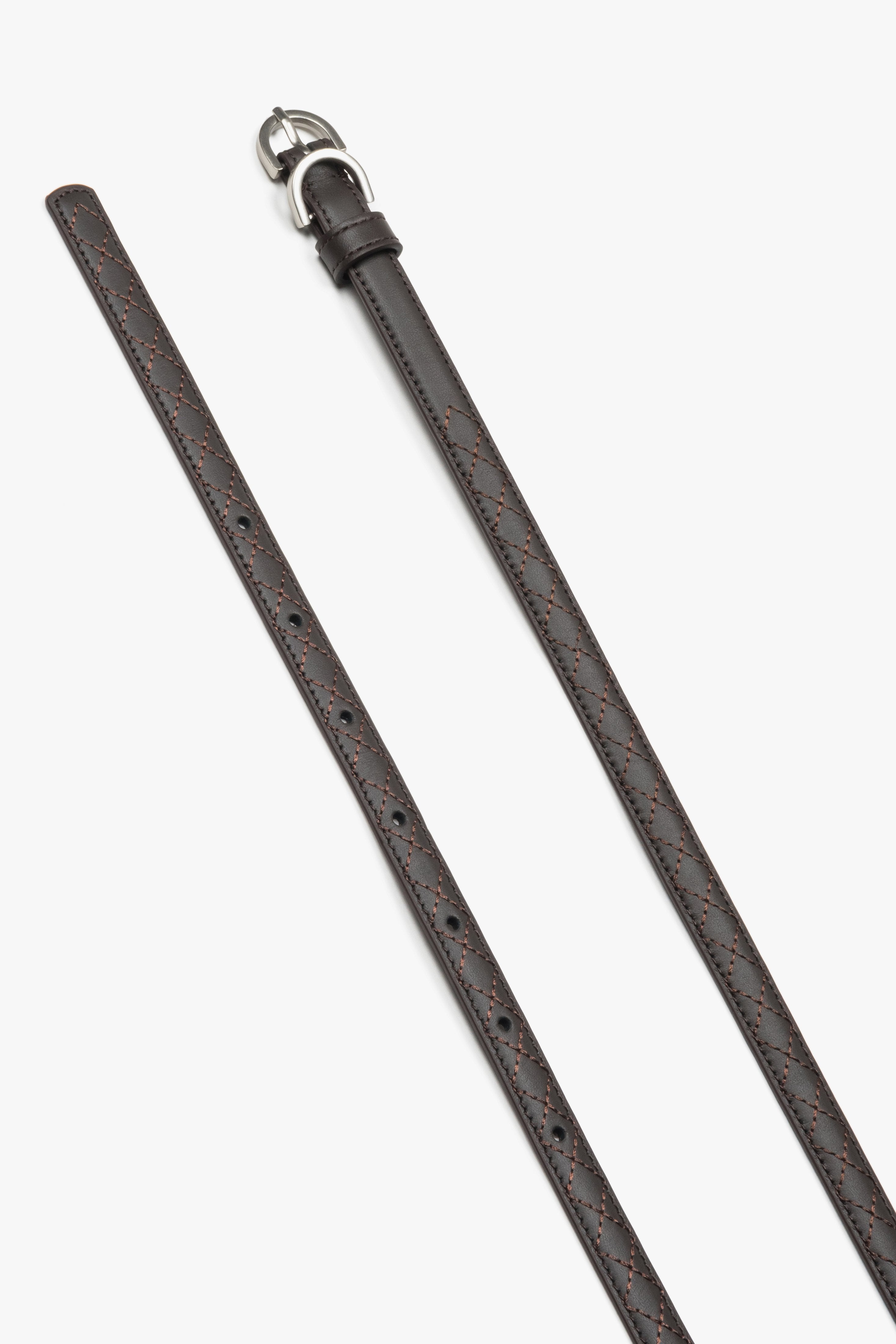 Embossed braided pattern on a dark brown natural leather belt.