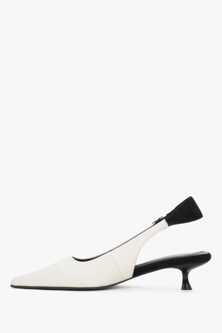 Side view of women’s white slingback heels with black strap and low funnel heel.