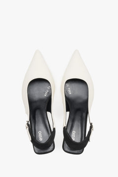 Top view of women’s white and black leather slingback heels by Estro.