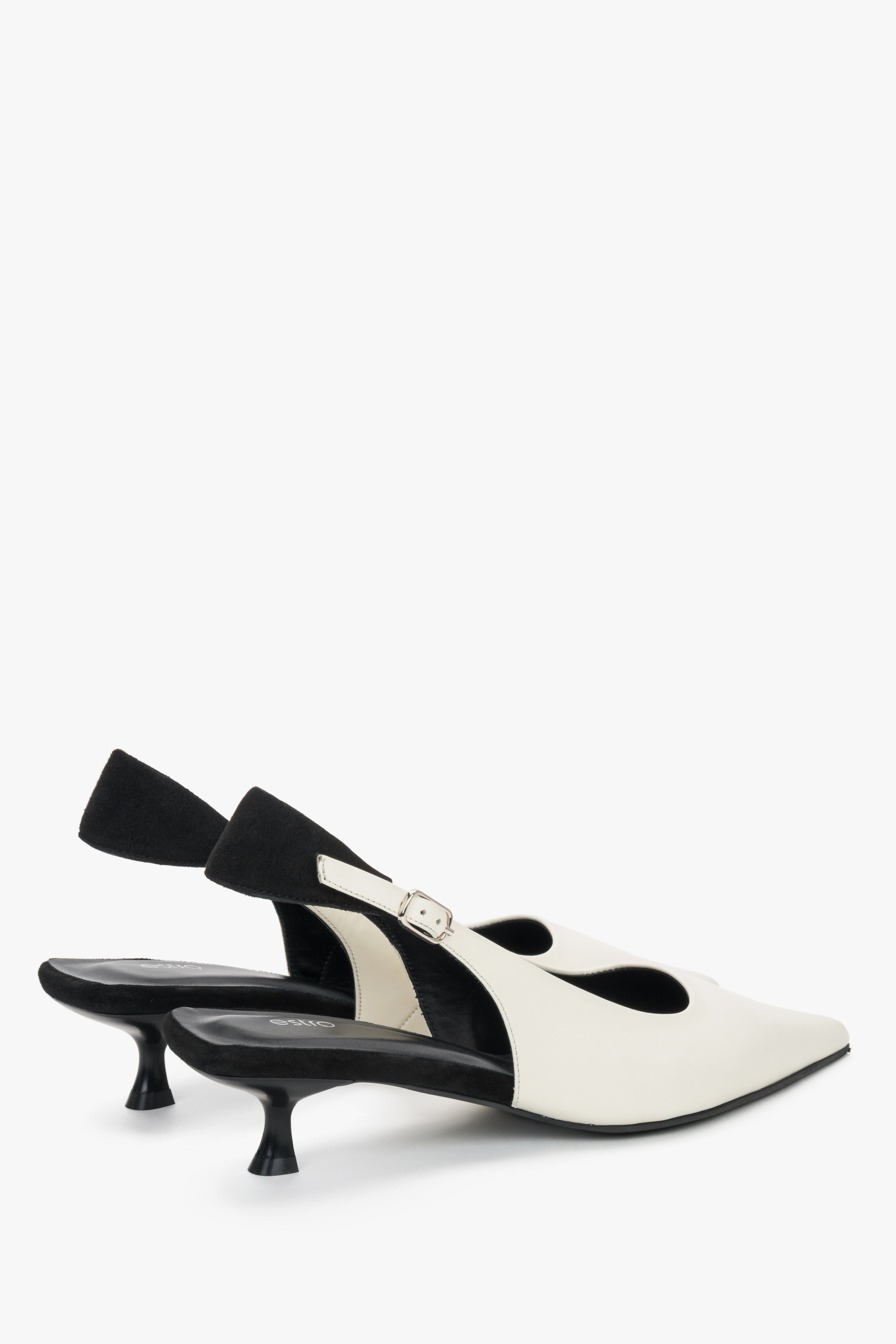 Women’s two-tone slingback shoes with white leather upper and black details.