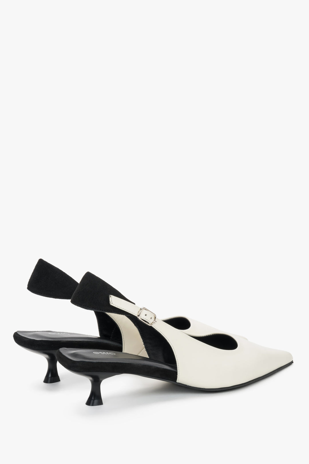 Women’s two-tone slingback shoes with white leather upper and black details.