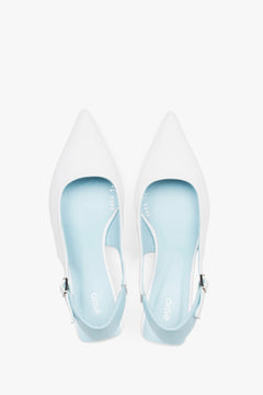 Top view of women’s white and blue leather slingback kitten heels.