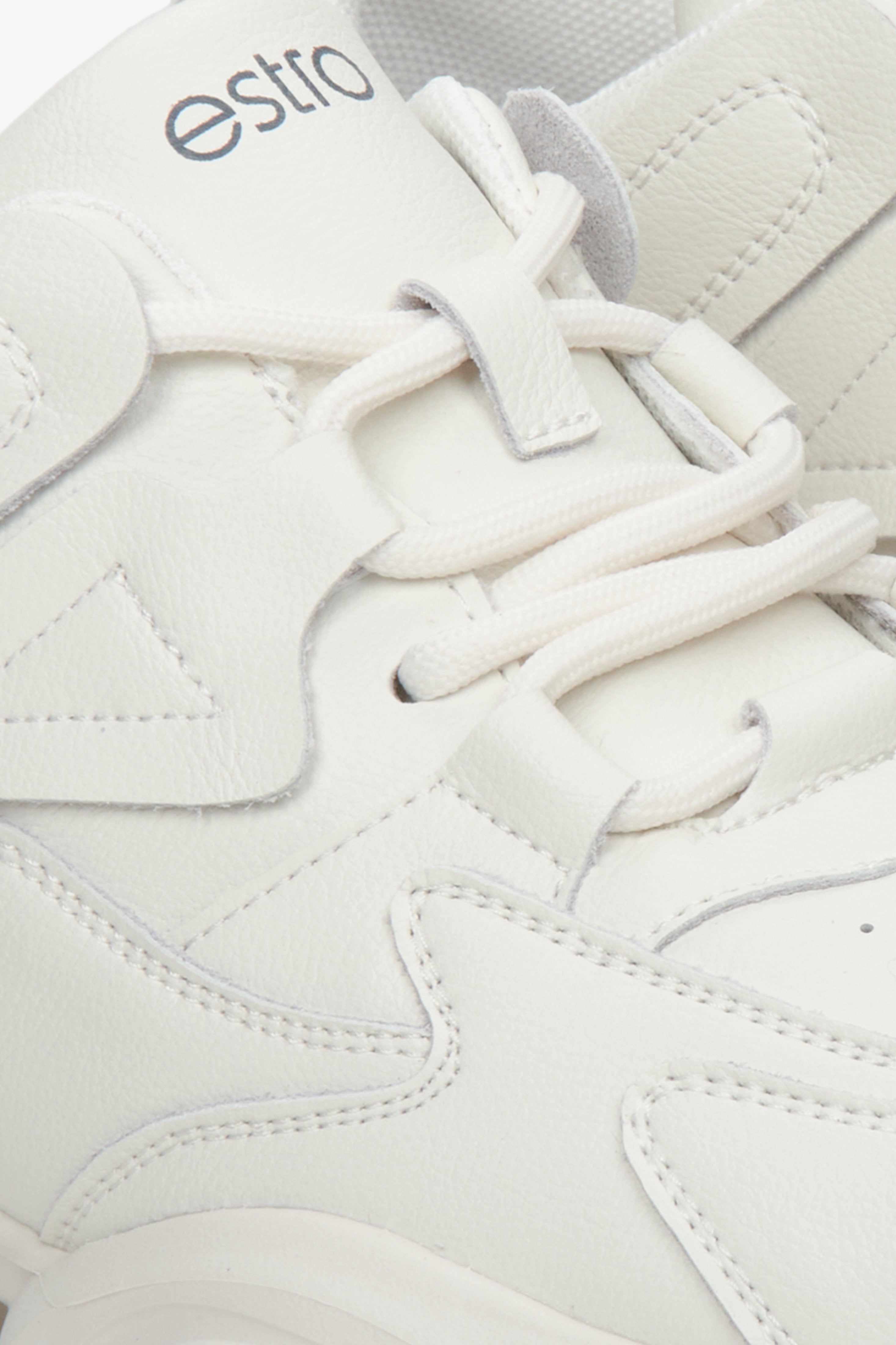 Women's white Estro sneakers made of genuine leather - close-up on the footwear details.