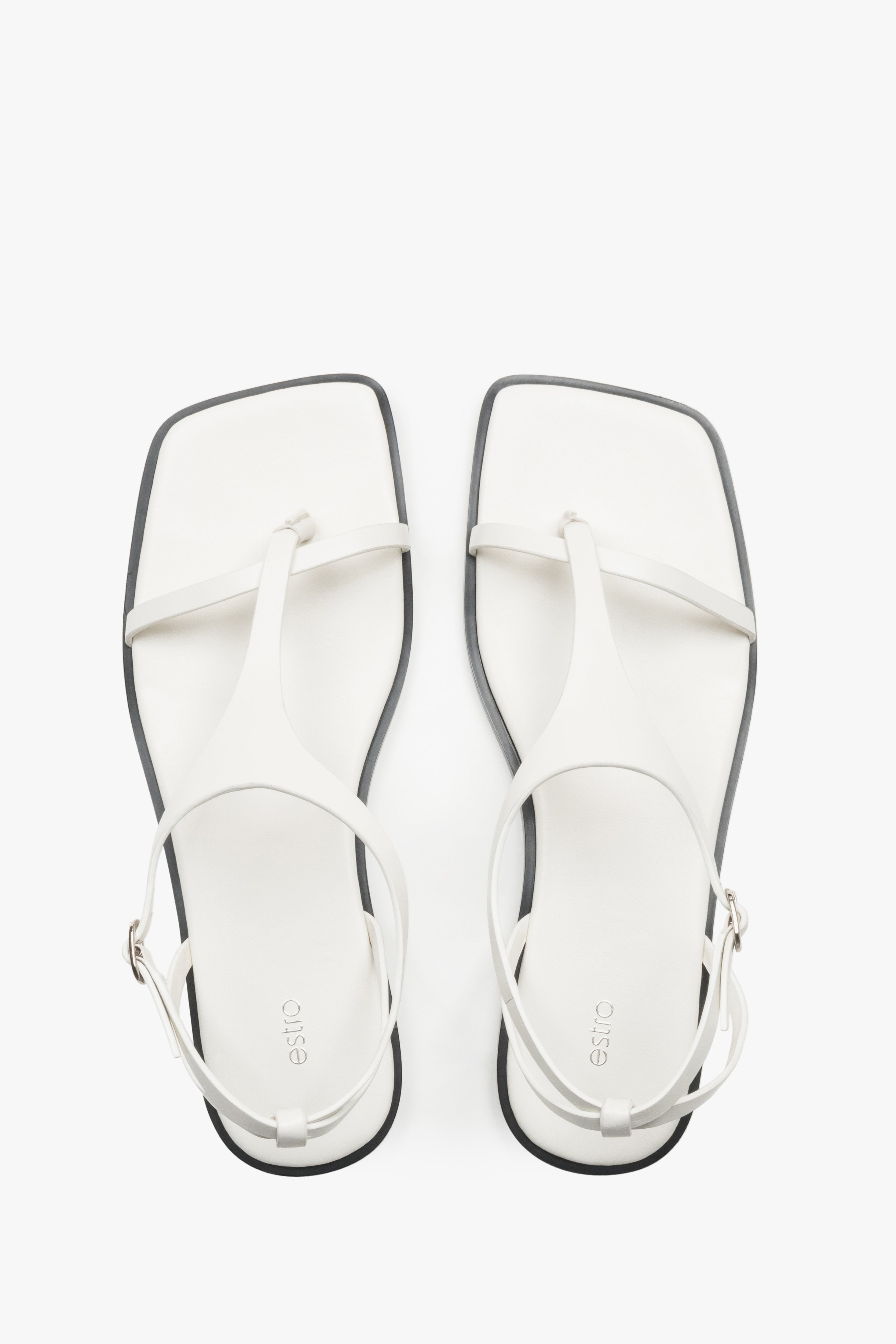 Women’s white flat sandals with a square toe and toe-post strap by Estro.
