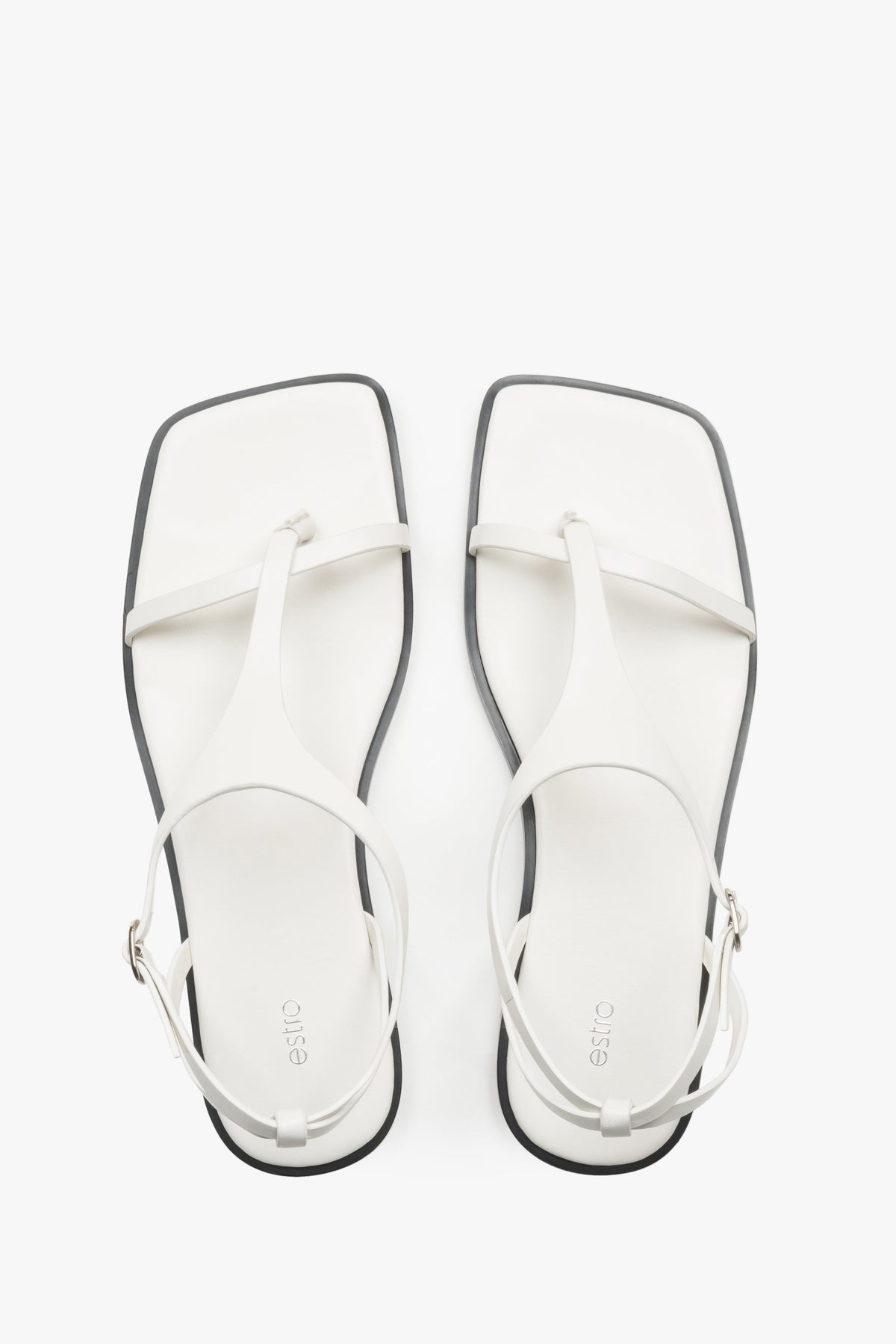 Women’s white flat sandals with a square toe and toe-post strap by Estro.