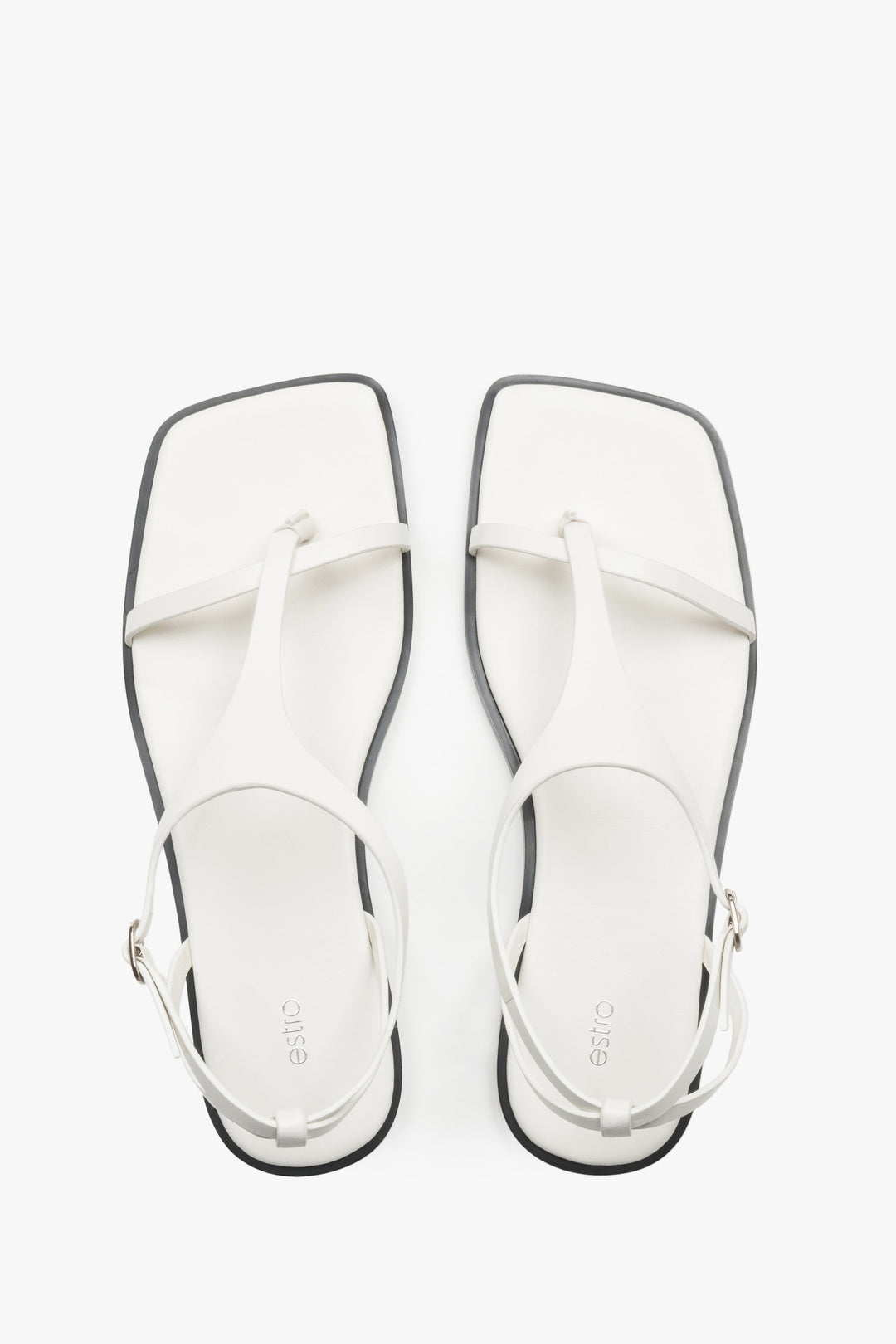 Women’s white flat sandals with a square toe and toe-post strap by Estro.
