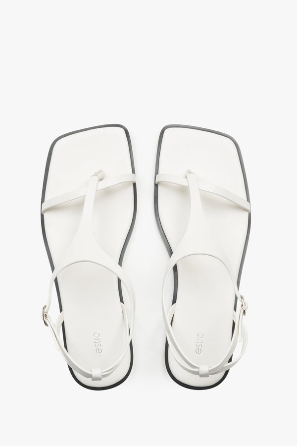 Women’s white flat sandals with a square toe and toe-post strap by Estro.