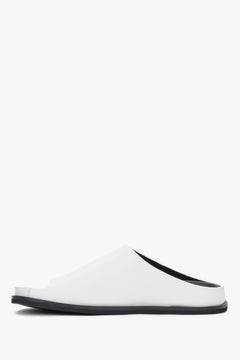 White women’s leather slide sandals on a flat sole.