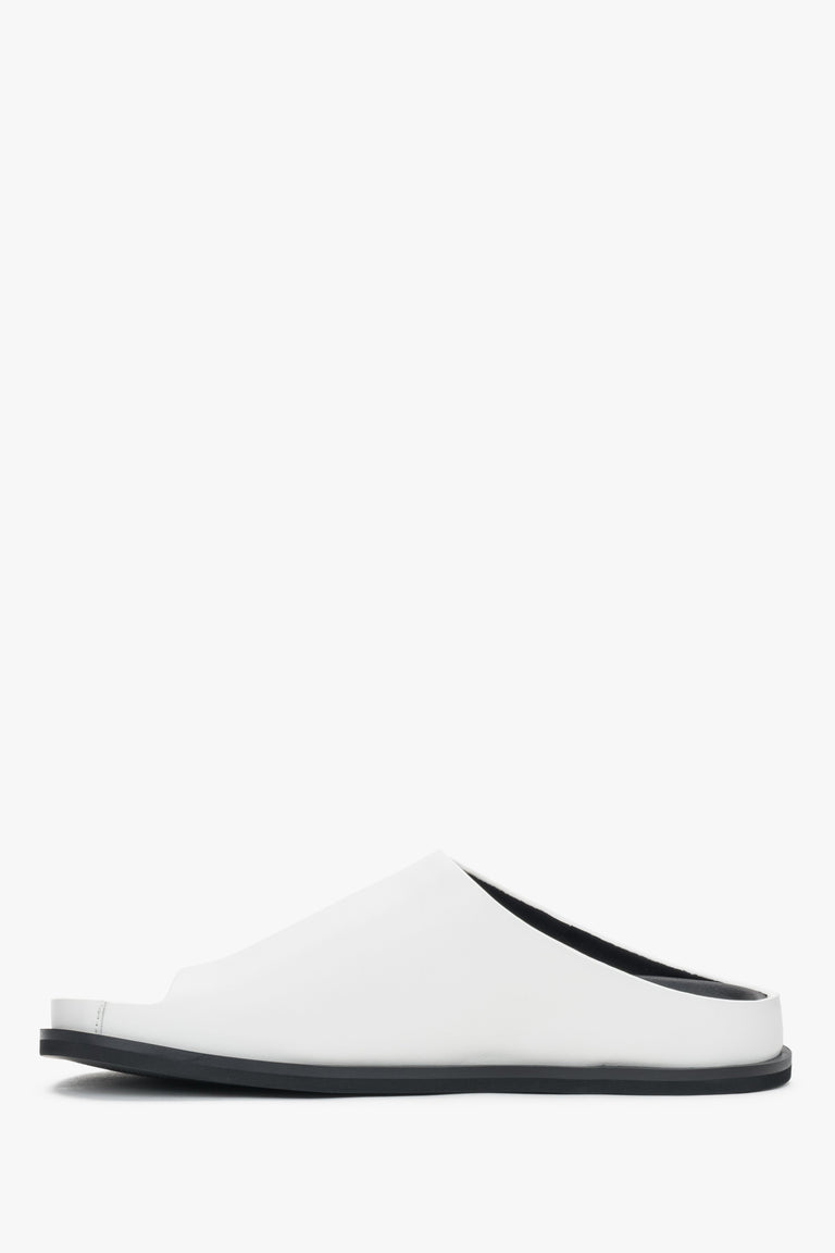 White women’s leather slide sandals on a flat sole.