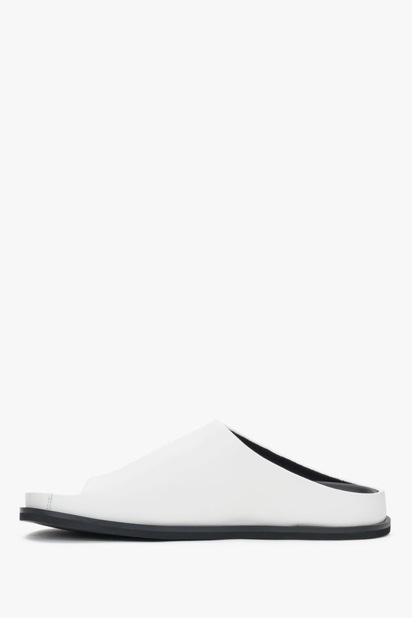 White women’s leather slide sandals on a flat sole.