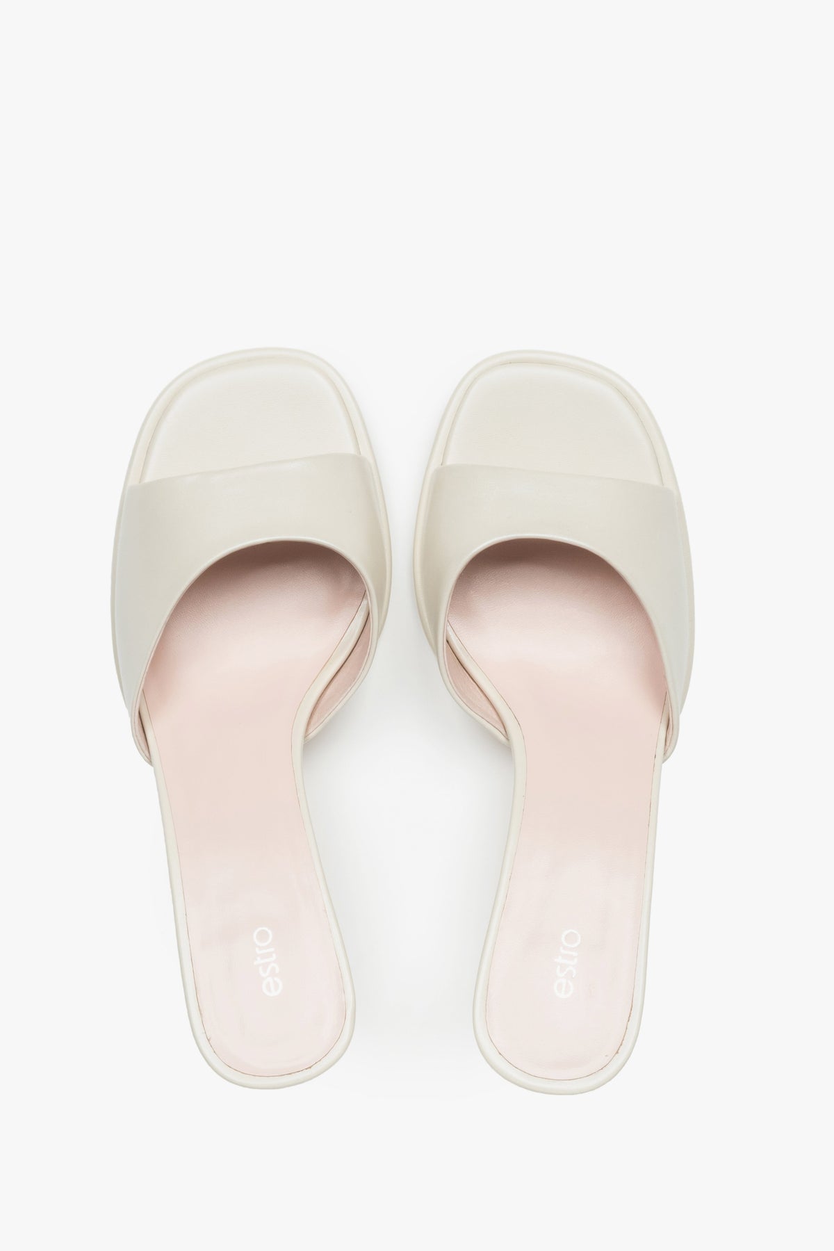 White heeled mules made of genuine leather.
