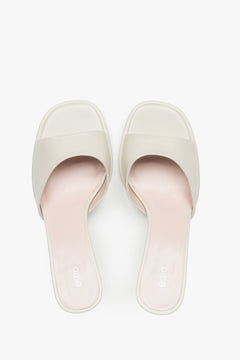 White heeled mules made of genuine leather.