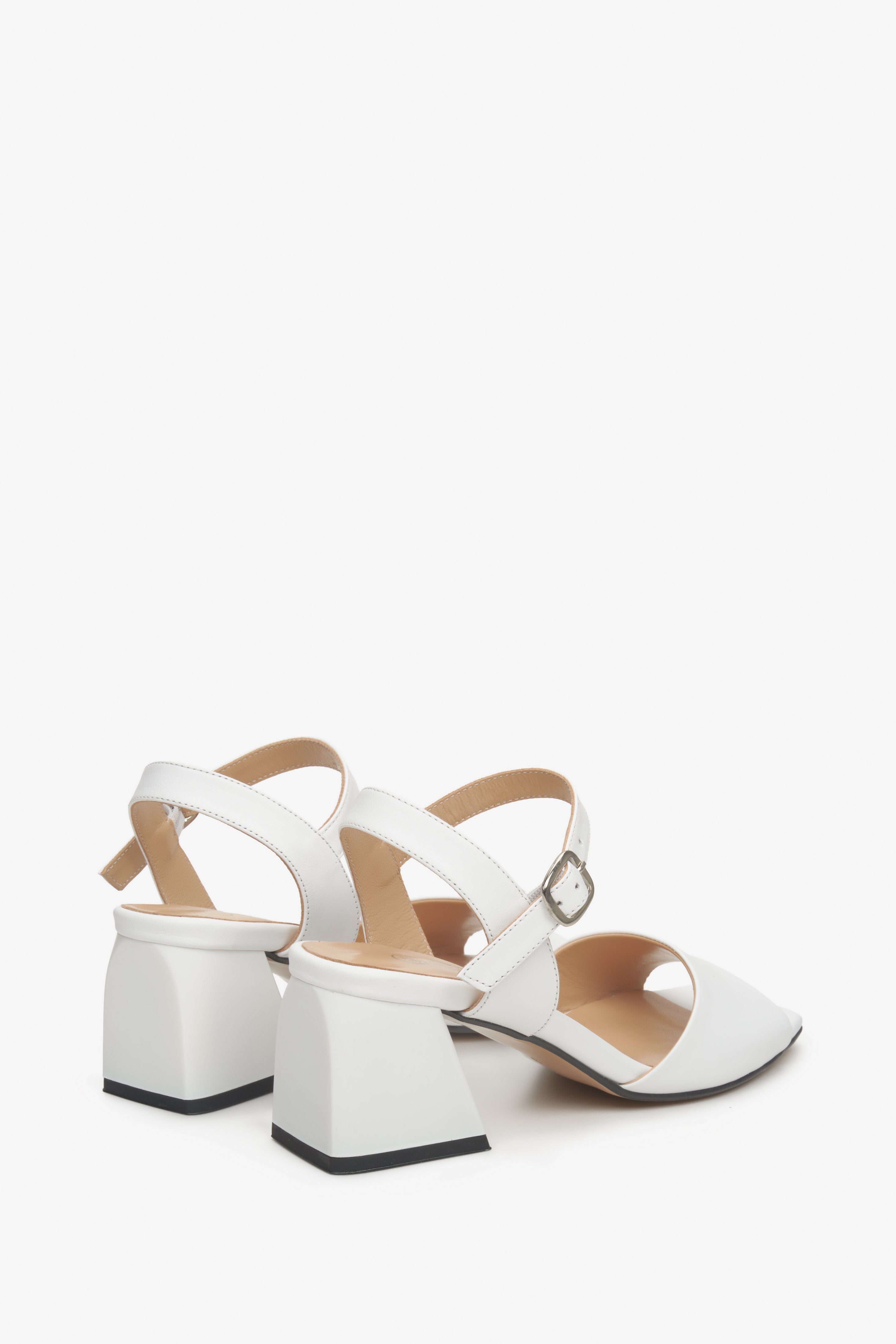 Women's white leather sandals by Estro - close-up on the block heel and side profile of the shoes.