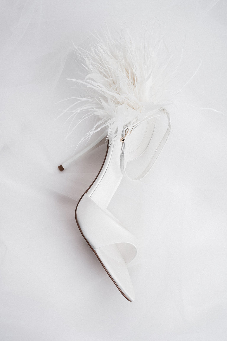 Close-up of white feather application for women's high heel sandals