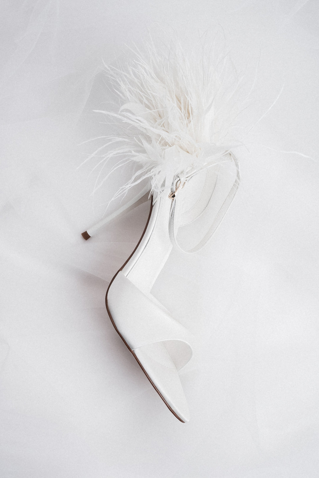 Close-up of white feather application for women's high heel sandals
