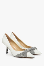 Women's white leather high heels with a silver Estro application.