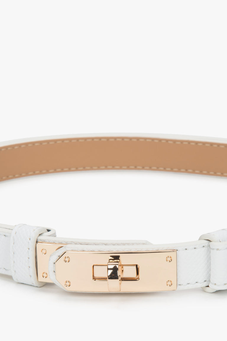 Women's white leather belt with a gold buckle.