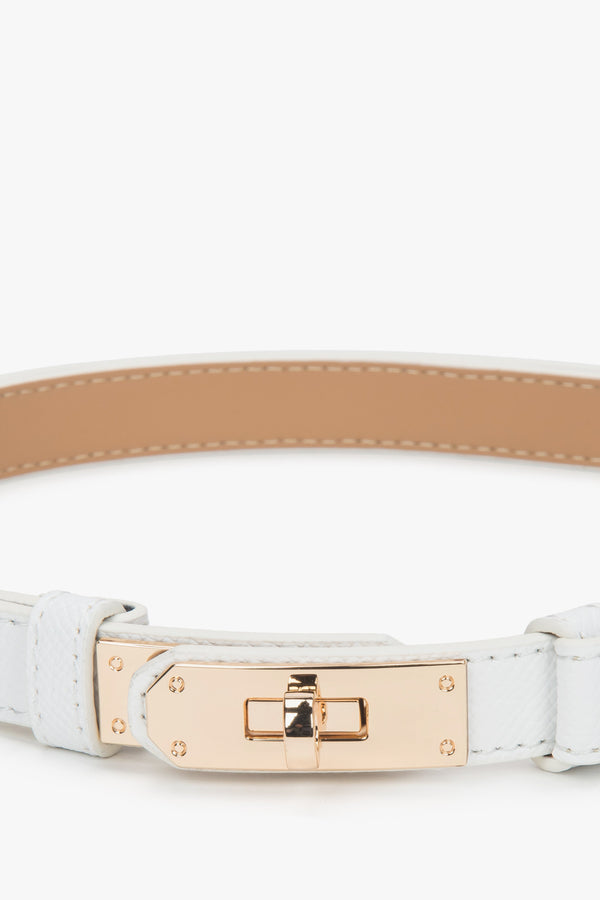 Women's white leather belt with a gold buckle.