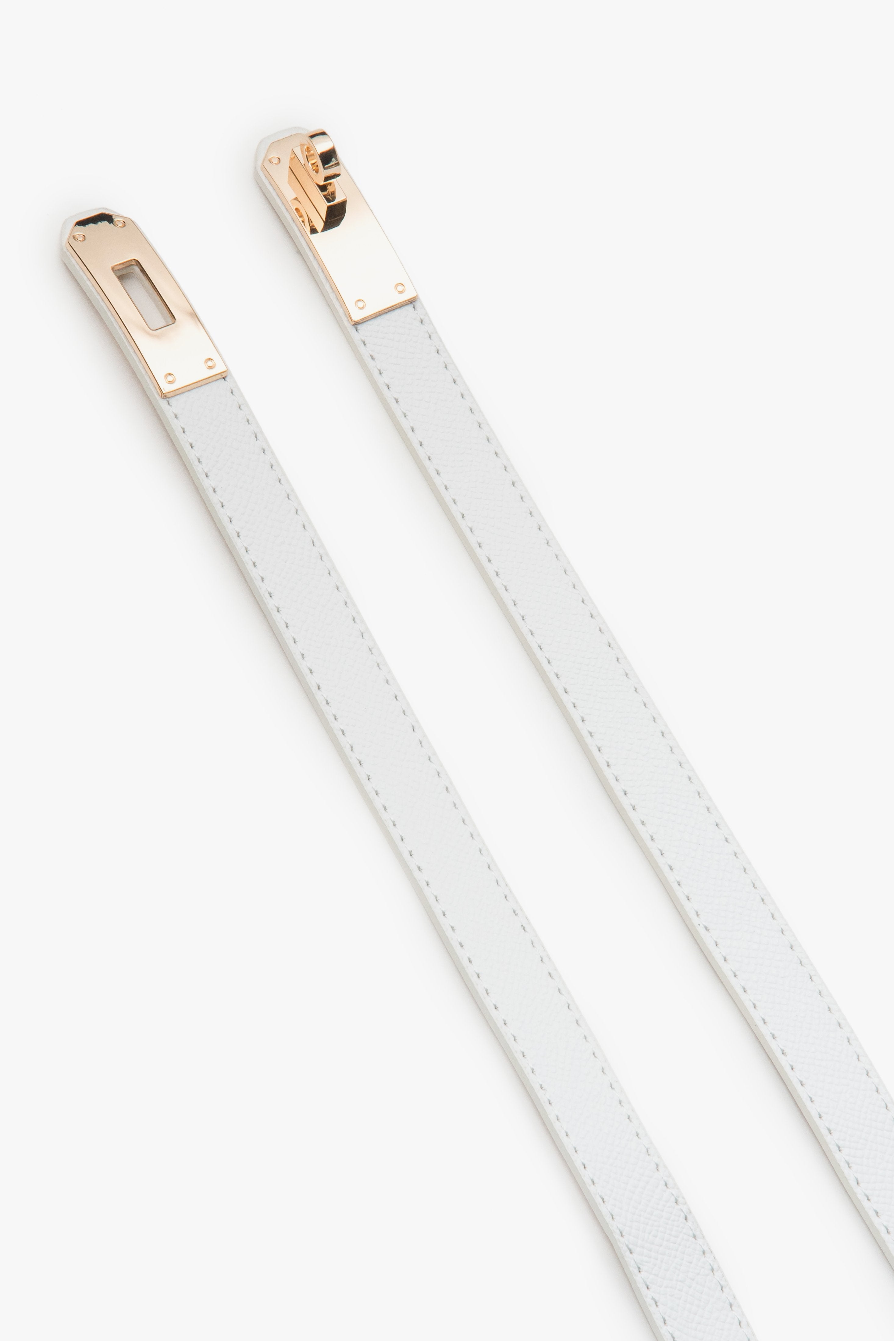 White women's leather belt with a gold buckle.