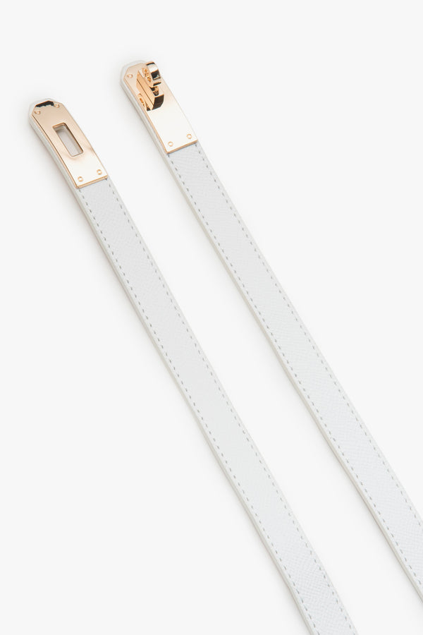 White women's leather belt with a gold buckle.