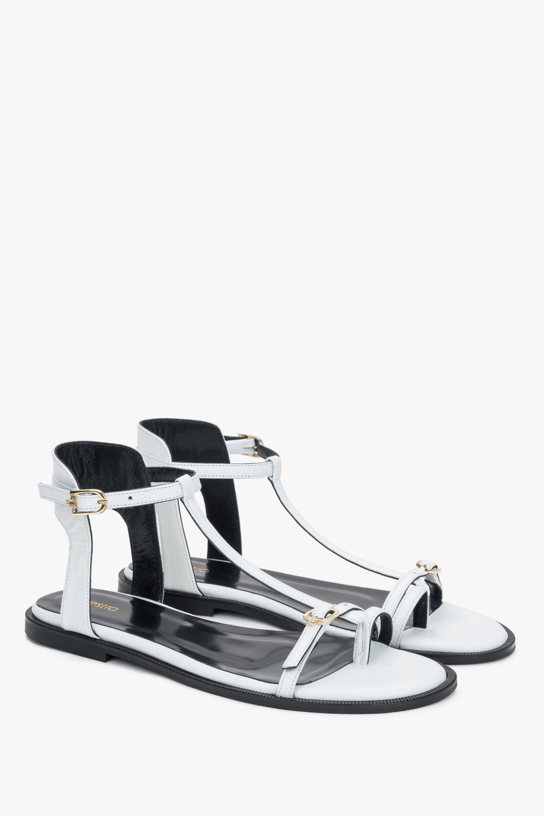 Side view of women's white leather flat sandals with toe loop by Estro