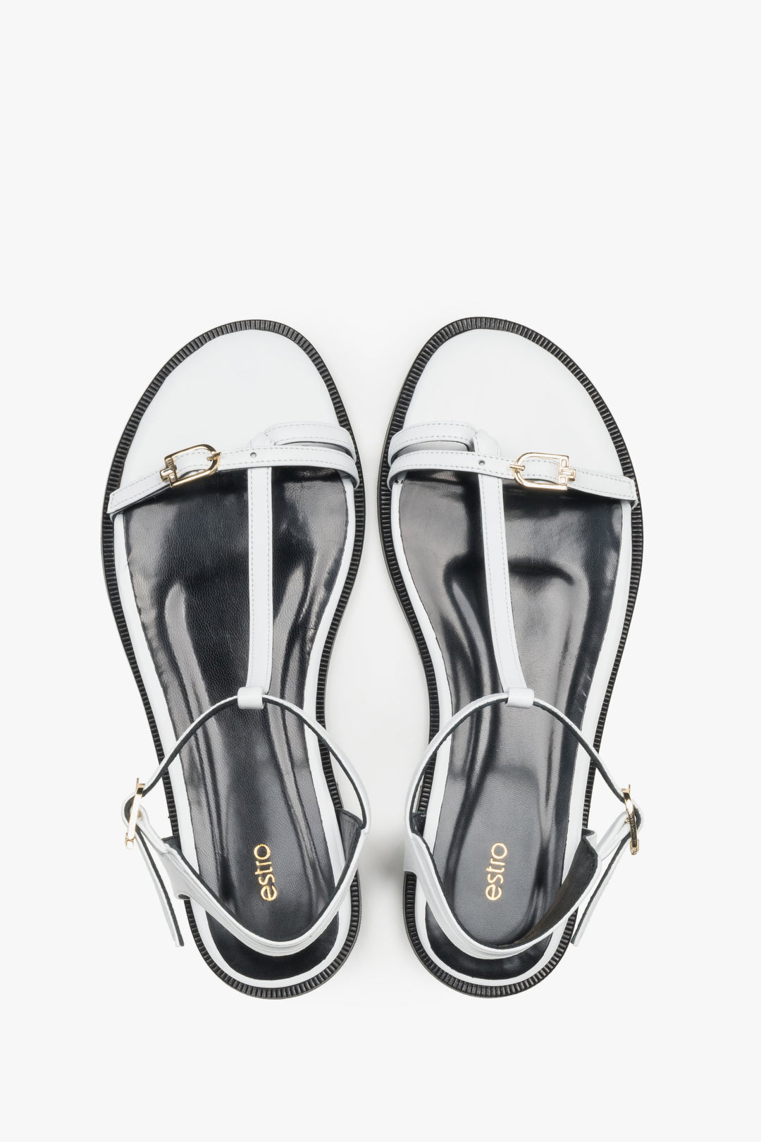 Top view of women's white leather flat sandals with gold details by Estro
