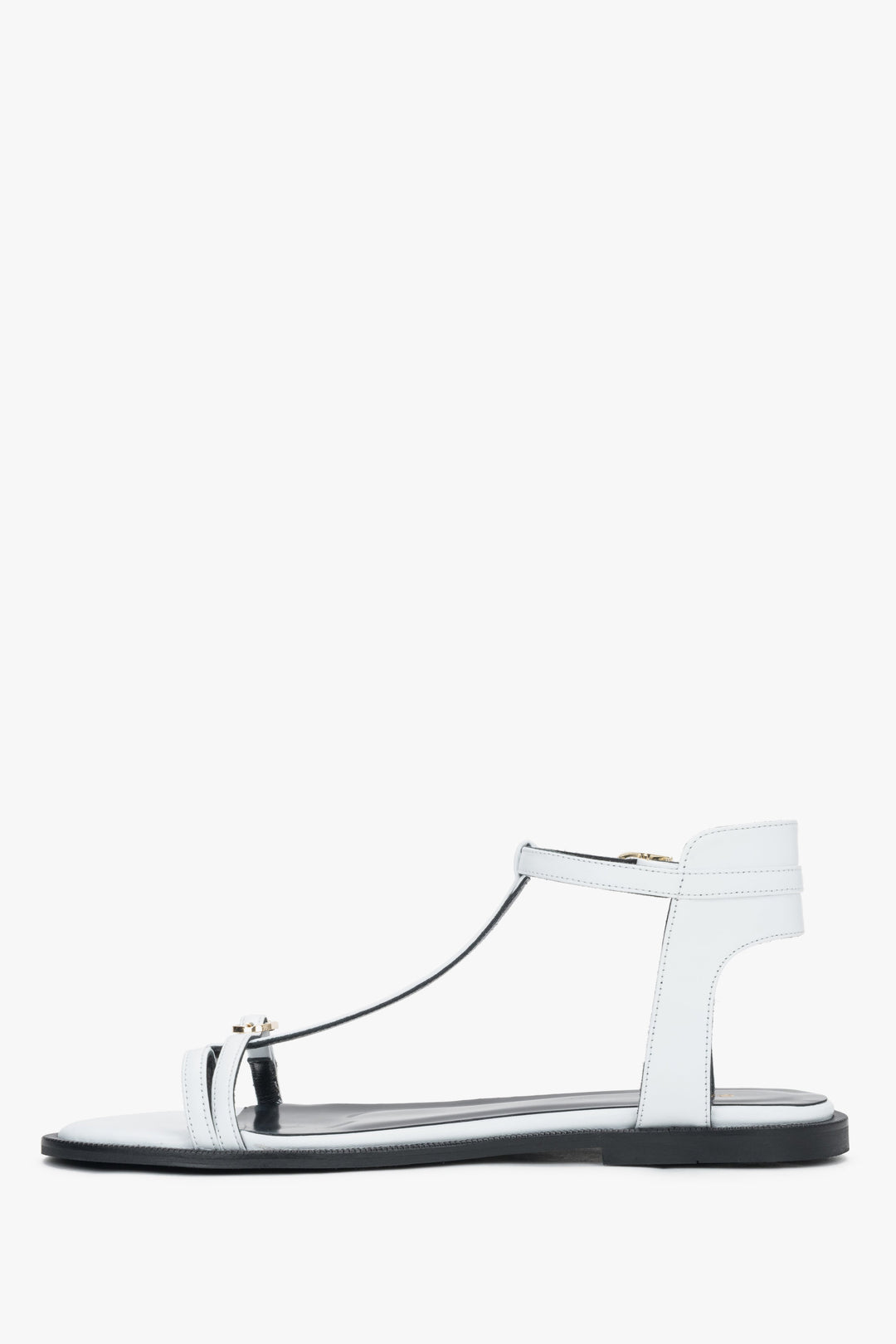 Low side view of women's white leather sandals with flat sole