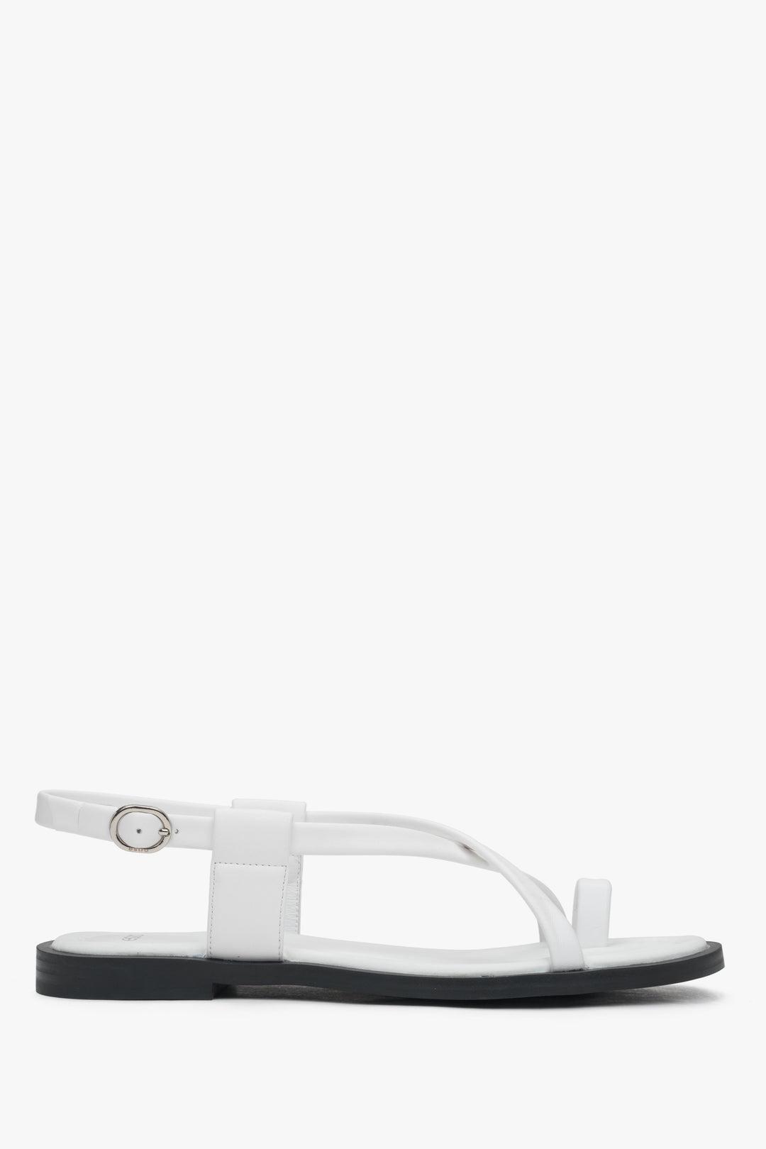 White women’s leather sandals on a flat sole with a toe loop – side view.