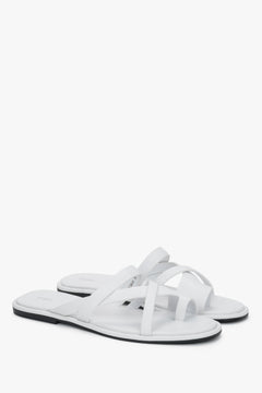 White women's leather slide sandals with crossed straps and toe loop, Estro.